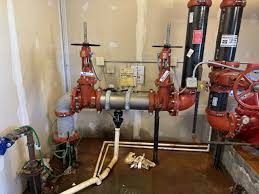 Reduced pressure zone backflow assemblies installed on a commercial water service